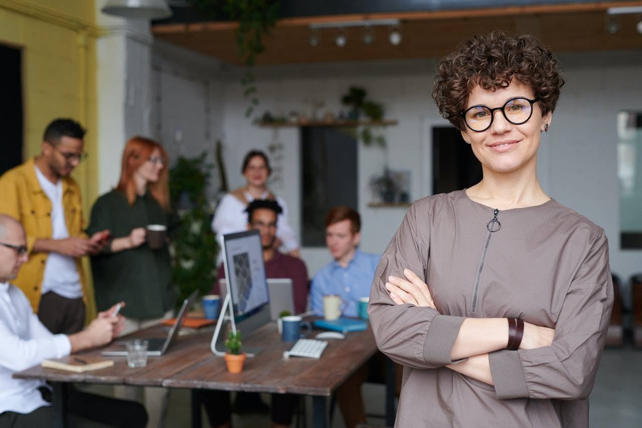 Happy Business Lady with colleagues in background