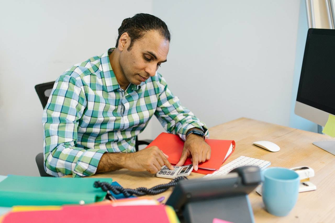 Man sitting at desk with files