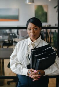 Lady holding files looking straight