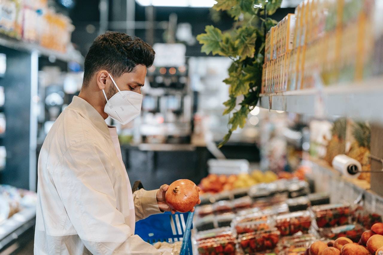 man inspecting vegetables