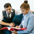 Two indian business professionals looking at a file
