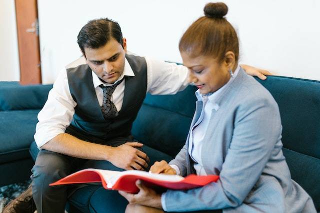 Two indian business professionals looking at a file