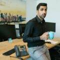Indian business owner holding a cup looking stressed