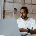 Indian entreprenuer at a laptop with a worried look