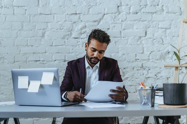 Indian business man looking at a document at his desk