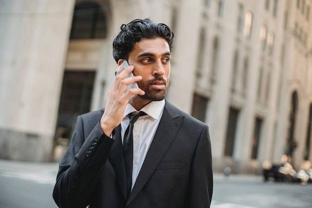 Indian business man on the phone looking concerned